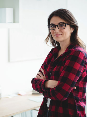Portrait of confident young woman standing in officeの写真素材