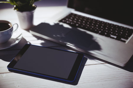 Tablet and laptop on table