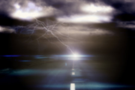 Road against sky with lightning during thunderstorm