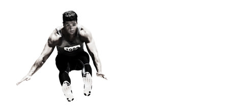 Full length of focused sportsman long jumping against white background