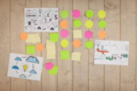 Defocused image of adhesive notes on wooden wall