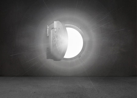 Shiny open safe in black wall