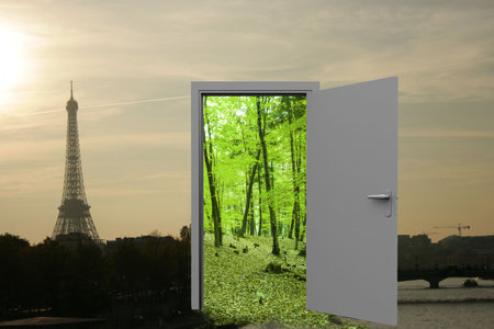 Digital image Eiffel Tower against sky and open door with treesの写真素材