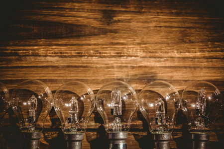 Light bulbs are kept in row on wooden table