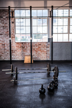 Gym equipment in exercise room against windowsの写真素材