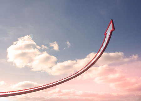 Red steps arrow pointing up against skyの写真素材
