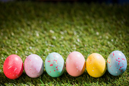 Colorful Easter eggs on grass in garden