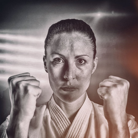 Portrait of confident female martial artist with fistsの写真素材