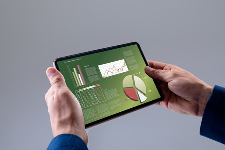 Caucasian businessman using tablet with data processing. Global business and data processing...