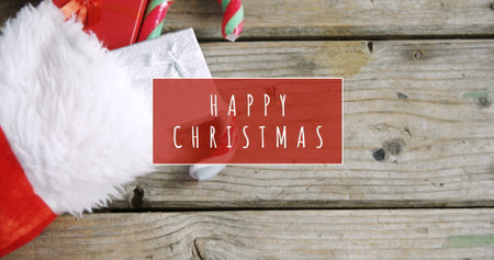 Digital composite of Happy Christmas text and stocking with giftsの写真素材