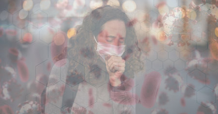 Digital illustration of macro Covid-19 cells floating over mixed race woman wearing face mask,...