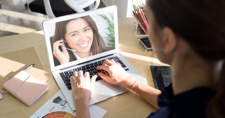 Woman using a laptop, having a video meeting and interacting online with a Caucasian woman wearing...