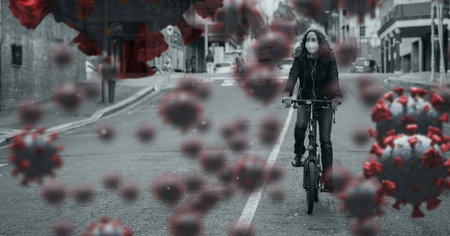 Digital illustration of macro Covid-19 cells floating over a woman wearing a face mask, riding a bike. Coronavirus Covid-19 pandemic concept digitally generatedの写真素材