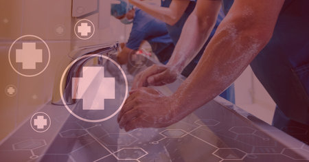 Digital illustration of doctors washing their hands over medical icons in the background. Medicine public health pandemic coronavirus Covid 19 outbreak concept digital composite.の写真素材
