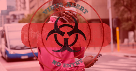 Digital illustration of a hazard sign with a bandage with a sign Virus alert No entry over a man wearing a face mask, walking on a street, using a smartphone in the background. Medicine public health pandemic coronavirus Covid 19 outbreak concept digital composite.の写真素材