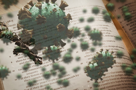 Digital illustration of macro Covid-19 cells floating over a Christian cross lying on an open Bible digital compositionの写真素材
