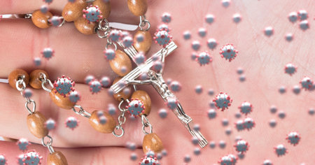 Digital illustration of macro Covid-19 cells floating over a crucifix on a rosary lying on a...