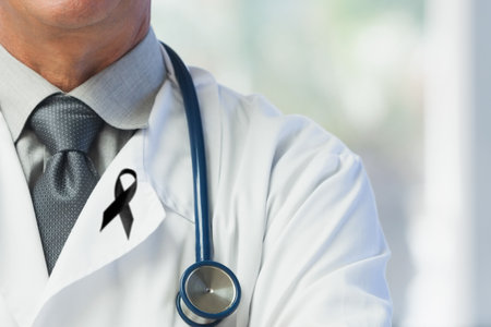 Digital illustration of Caucasian male doctor wearing black ribbon pin, crossing his arms. Medical grief cancer concept digital compositeの写真素材