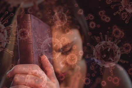 Digital illustration of macro Covid-19 cells floating over a Caucasian woman praying, holding Bible....