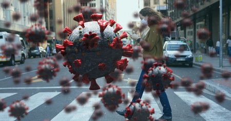Digital illustration of macro Covid-19 cells floating over a woman wearing a face mask, using a smartphone, crossing the street. Coronavirus Covid-19 pandemic concept digitally generatedの写真素材