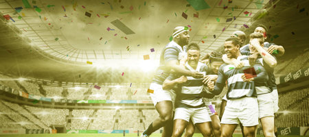 Team of multi-ethnic rugby players playing rugby at a sports stadium, wearing team strip, celebrating a win, confetti falling, digital composite.の写真素材