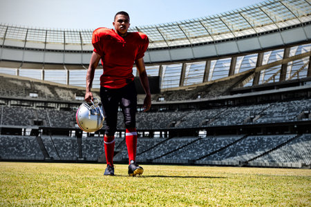 American Football Player against rugby goal post on a sunny day in the stadiumの写真素材
