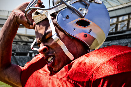 American Football Player against rugby goal post on a sunny day in the stadiumの写真素材
