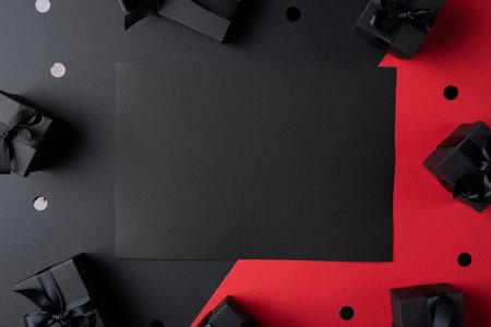 Composition of presents and black card with copy space on gray and pink background. Retail, shopping and black friday concept.の写真素材