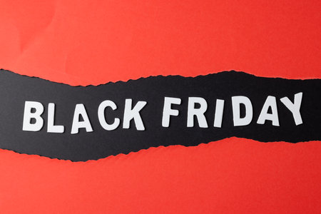 Composition of pink paper cards and black friday text on gray background. Retail, shopping and black friday concept.の写真素材