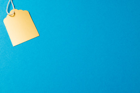 Composition of gift tag with copy space on blue background. Retail, shopping and black friday concept.の写真素材