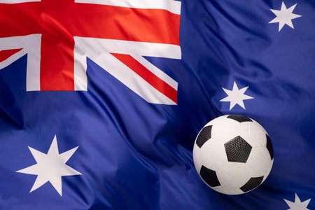 Composition of football over national flag of australia. Sport, movement, training and active lifestyle concept.の写真素材
