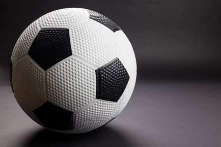 Composition of football on black background with copy space. Sport, movement, training and active...