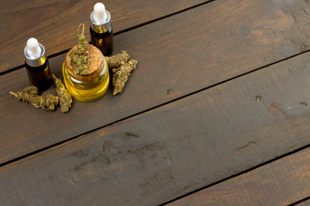 Image of cbd oil in bottles on wooden background. Cbd oil, medical marihuana, cannabis medicament concept.の写真素材