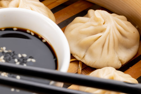 Close up of asian steamed dumplings, soy sauce and chopsticks in wooden dish. Asian tasty home cooked food and healthy eating.の写真素材