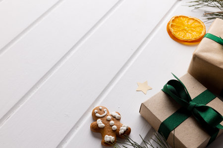 Image of christmas decoration with gingerbread man and copy space on white background. Christmas,...