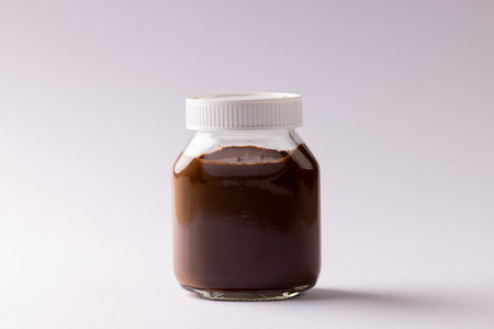 Image of jar of chocolate cream on white background. Food, breakfast, nutrition and american cuisine...