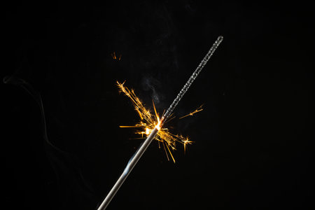 Composition of close up of new years sparkler on black background. New year's eve party,...