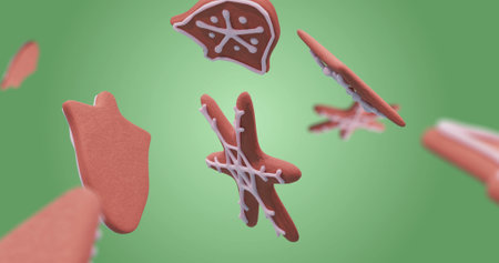 Image of gingerbread falling at christmas over green background. Christmas, tradition and digital interface concept digitally generated image.の写真素材