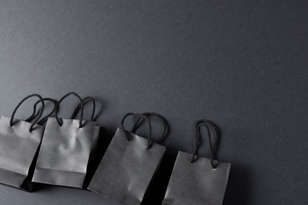 Composition of gray paper shopping bags on gray background. Retail, shopping and black friday concept.の写真素材
