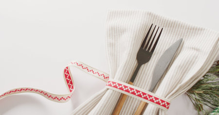 Image of christmas place setting with cutlery and copy space on white background. Christmas, tradition and celebration concept.の写真素材