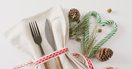 Image of christmas place setting with cutlery and copy space on white background. Christmas, tradition and celebration concept.の写真素材