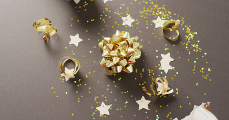 Image of christmas crackers, stars and decoration on grey background. Christmas, tradition and...