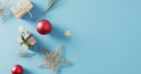Image of christmas decoration with baubles and copy space on blue background. Christmas, tradition and celebration concept.の写真素材