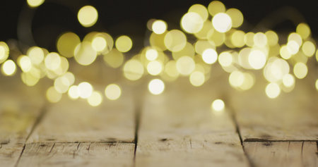 Image of close up of christmas fairy lights on wooden background. Christmas, tradition and celebration concept.の写真素材