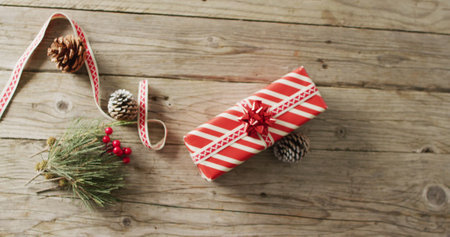 Image of christmas gifts with christmas decoration and copy space on wooden background. Christmas,...