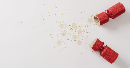 Image of red christmas cracker, stars and decoration with copy space on white background. Christmas, tradition and celebration concept.の写真素材