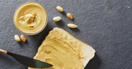 Image of close up of toast with peanut butter on gray background. Food, party and copy space concept.の写真素材