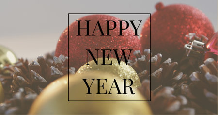 Image of happy new year text in black frame over christmas baubles and pine cones. New year,...
