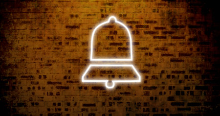 Composite of illuminated digital notification bell icon against old brick wall, copy space. Social media, information, reminder, symbol and technology concept.の写真素材
