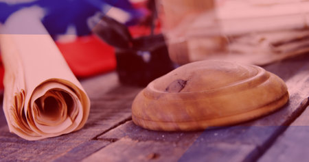 Close-up of wooden sound block and legal documents rolled up on table in courtroom. Composite, copy space, law day, paper, block and justice concept.の写真素材